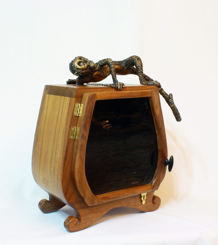 Bronze sculpture and wood jewelry chest by Alicia Jones.