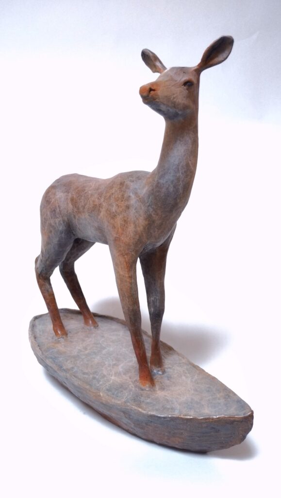 Bronze sculpture by Alicia Jones. This sculpture depicts a deer standing on a boat.