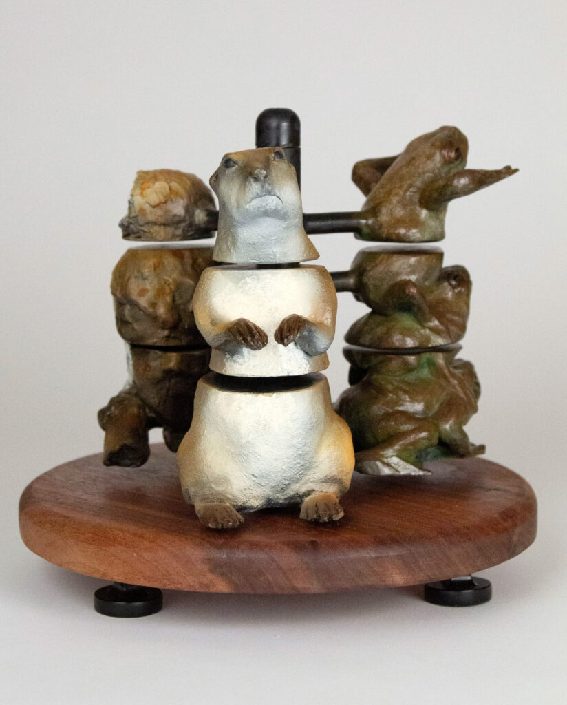 Bronze sculpture made by Alicia Jones of a prairie dog, owl and toads.