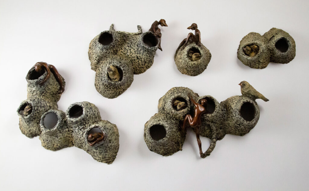 Bronze sculpture by Alicia Jones. This sculpture depicts a swallow colony with human invaders.